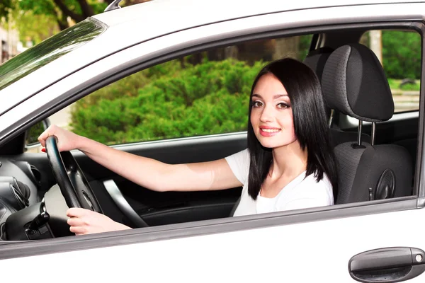 Young brunette woman in new car — Stock Photo, Image