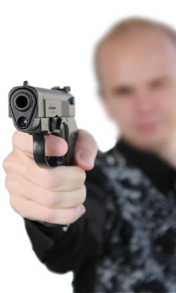 Молодой человек целился с пистолетом в руке — стоковое фото