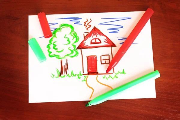 Child's drawing and pens on the table — Stock Photo, Image