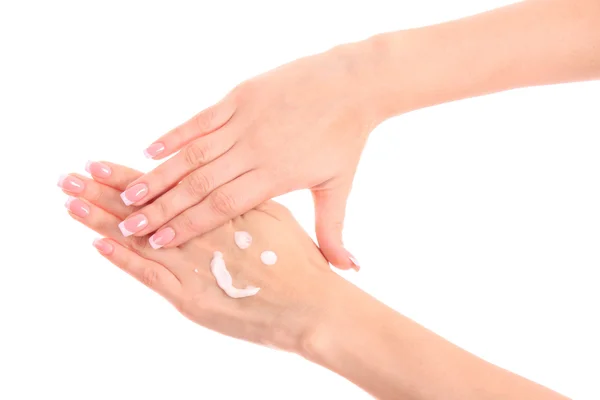 Closeup of beautiful female hands applying hand cream isolated o — Stock Photo, Image