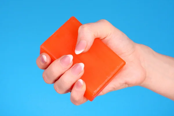 Soap in hand on blue background — Stock Photo, Image