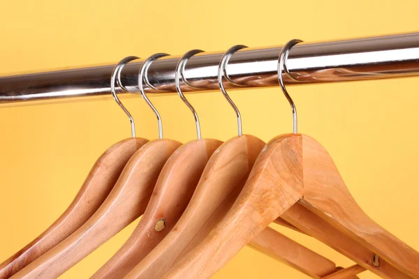 Wooden coat hangers on a clothes rail — Stock Photo, Image
