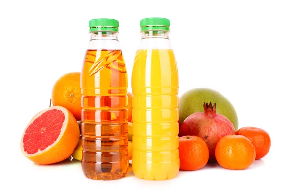 Bottles of juice with ripe fruits on white background — Stock Photo, Image