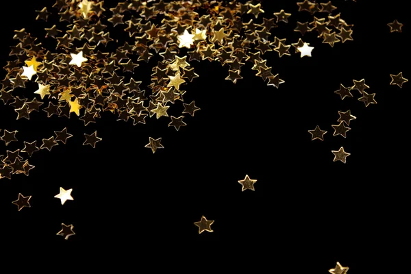 Decoração de estrelas douradas isoladas em preto — Fotografia de Stock