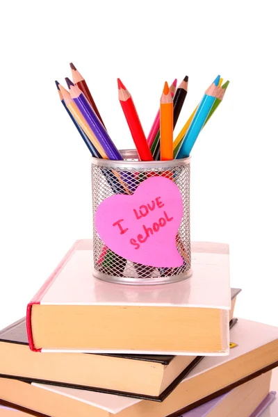 Kände pennor med en kreditnota anteckning säger "Jag älskar skolan" på vit backg — Stockfoto