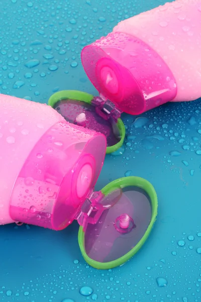 Shampoo bottles on blue — Stock Photo, Image
