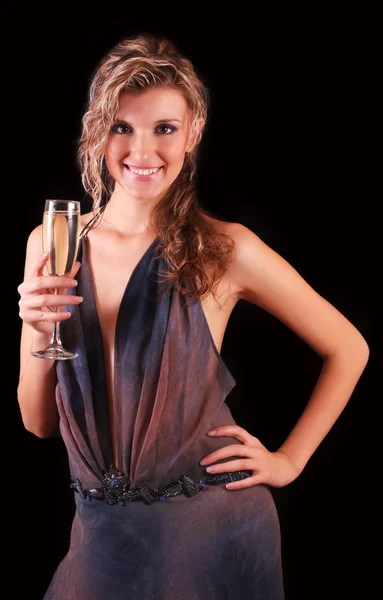Beautiful woman with a glass of champagne on black background — Stock Photo, Image