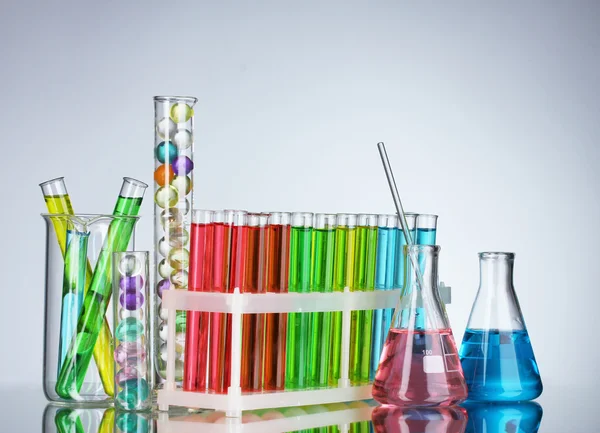 Test-tubes with liquid on gray background — Stock Photo, Image