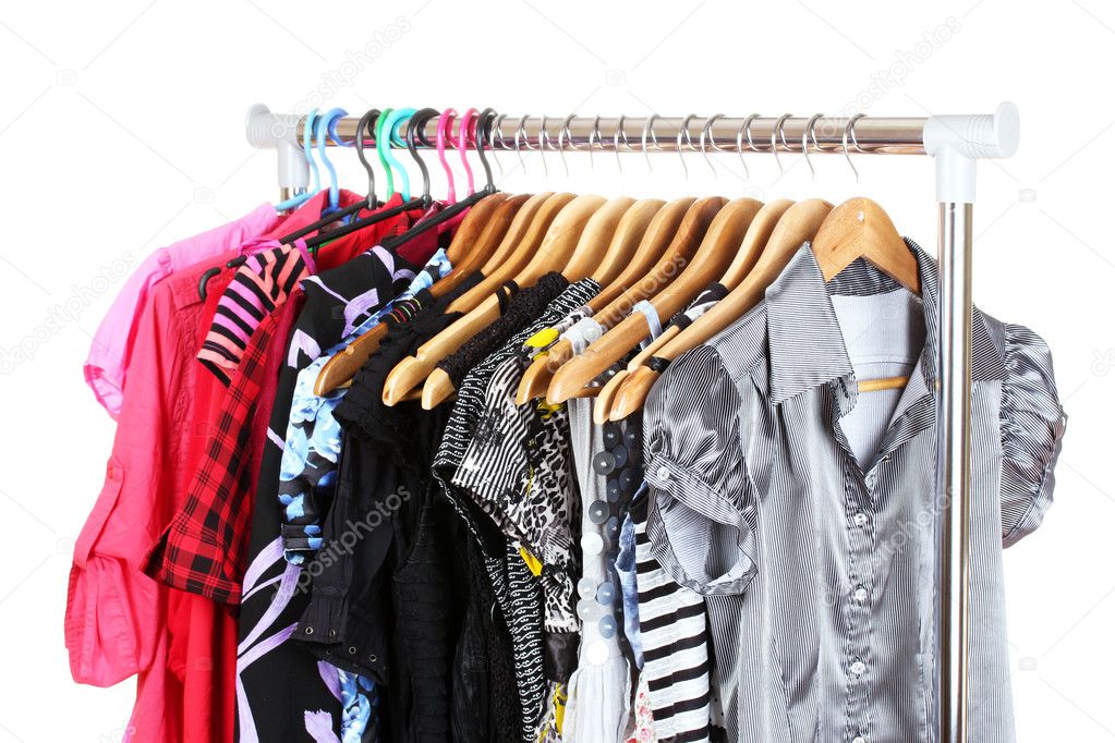 Different clothes on wooden hangers