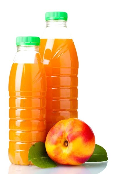 Peach juice in bottles and nectarine isolated on white — Stock Photo, Image