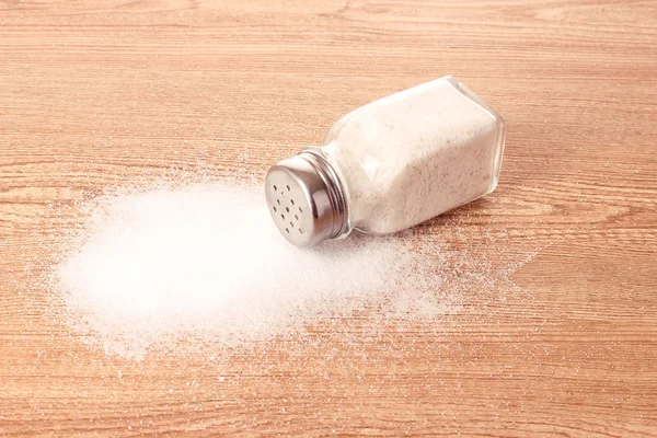 Salt shaker on wooden background — Stock Photo, Image