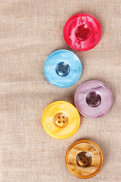 Botões de costura brilhantes em tecido cinza — Fotografia de Stock