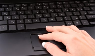 Woman hand on laptop keyboard clipart