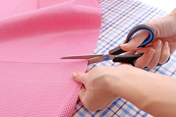 Dressmaker cuts scissors fabrics — Stock Photo, Image