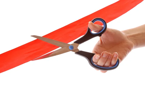 Červená stuha s nůžkami izolovaných na bílém — Stock fotografie