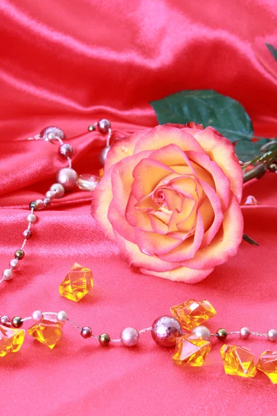 Rosa Rose auf dem textilen Hintergrund — Stockfoto