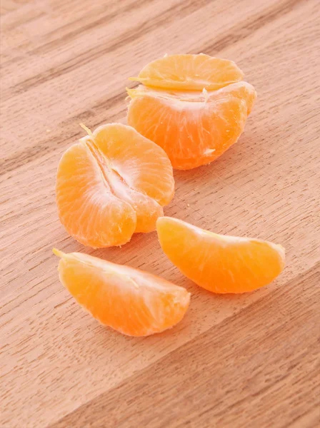 Tangerine segments on wooden background — Stock Photo, Image