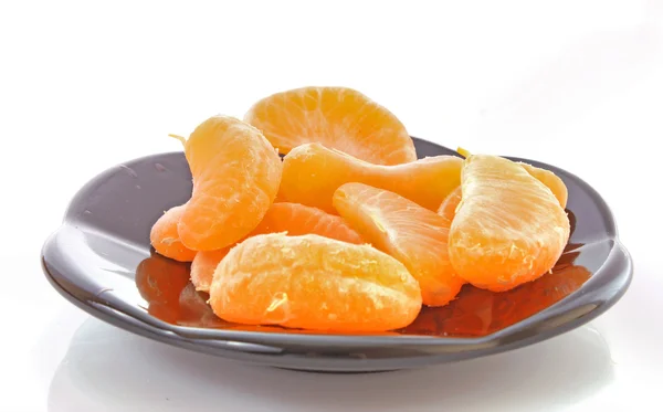 Fresh mandarin on the black plate — Stock Photo, Image