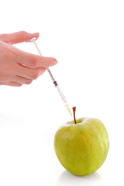 Zelené jablko s injekční stříkačkou na bílém pozadí — Stock fotografie