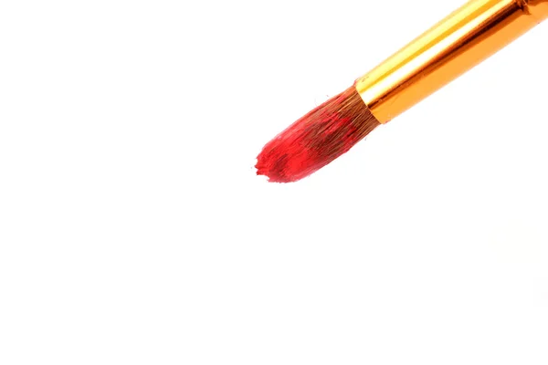 Brush in red paint closeup — Stock Photo, Image