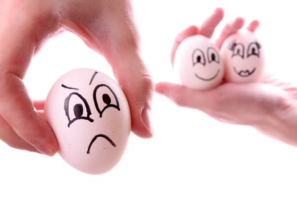 Üç yumurta üzerinde beyaz izole ellerinde — Stok fotoğraf