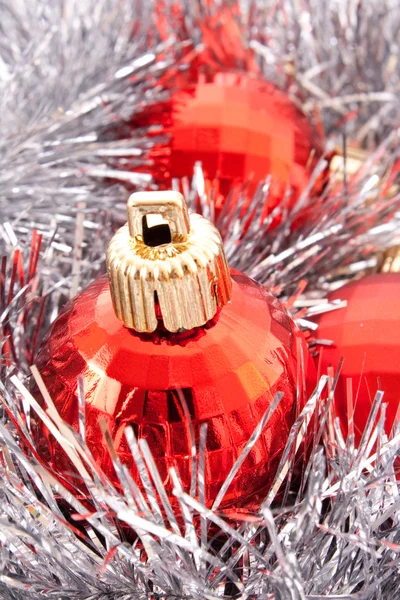 Boules de Noël rouges parmi la décoration scintillante argentée — Photo