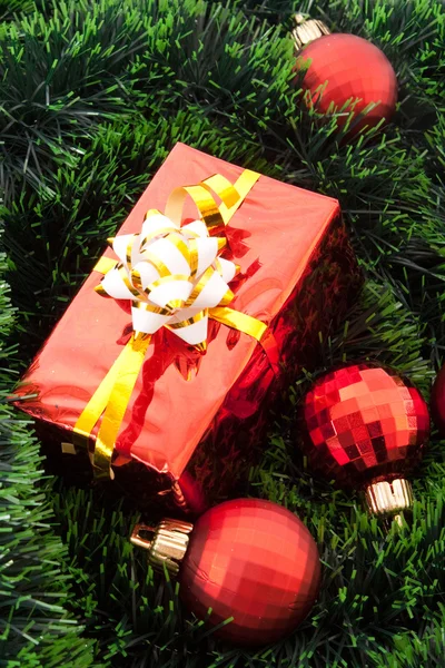 Boules de Noël rouges et cadeaux parmi le nouvel arbre de l'année verte — Photo
