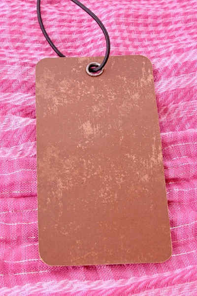 Label on pink textile background — Stock Photo, Image