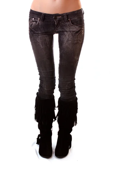 Žena nohy v džínách na bílém pozadí — Stock fotografie