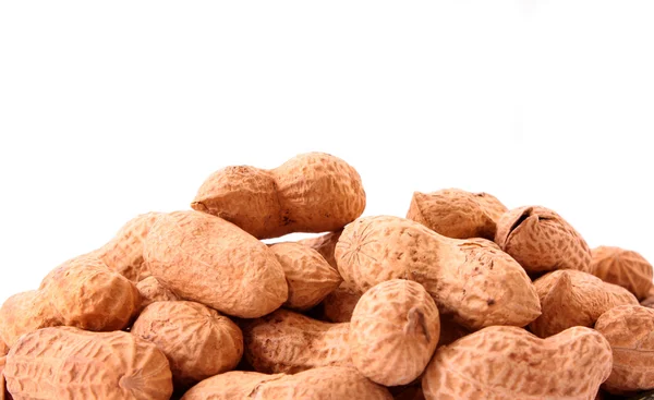 Many peanuts on white background — Zdjęcie stockowe