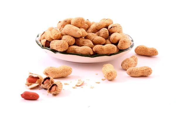 Few peanuts and dish isolated on white — Stock Photo, Image