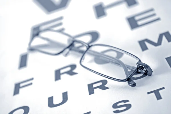 Glasses on the test chart — Stock Photo, Image