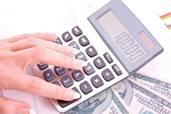 Calculator and woman hand counts money — Stock Photo, Image