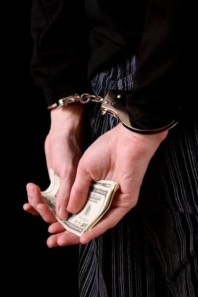 Homme menotté et dollars sur noir — Photo