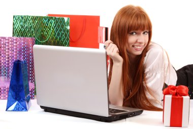 Beautiful, young, redhead woman with color shopping bags shoppin clipart