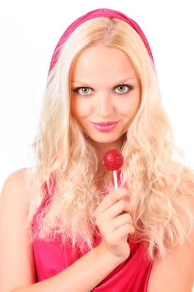 Belle fille blonde en robe rose avec des bonbons sur blanc — Photo