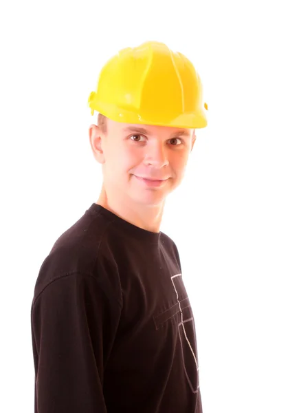 Yakışıklı genç adam kask WHI izole bina sarı — Stok fotoğraf