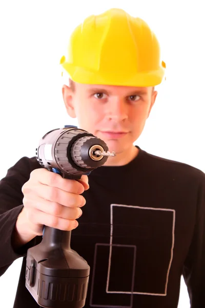 Handsome young men in a yellow building helmet and drill in the — Stock Photo, Image