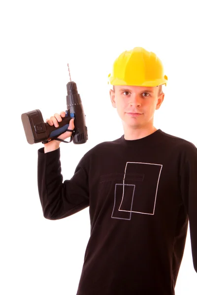 Handsome young men in a yellow building helmet and drill in th — Stock Photo, Image