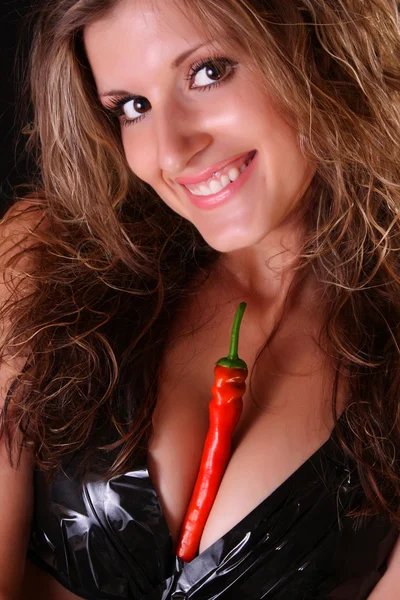 Portrait of beautiful sexy woman with hot chili pepper on black — Stock Photo, Image