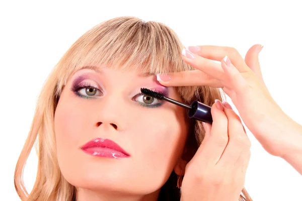 Beautiful young blonde woman applying mascara on her eyelashes — Stock Photo, Image