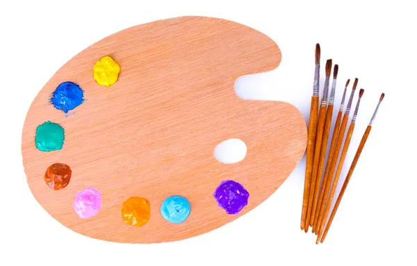 Wooden art palette with blobs of paint and a brush on white back — Stock Photo, Image