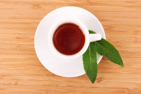 Cup with mint on wooden background — Stock Photo, Image