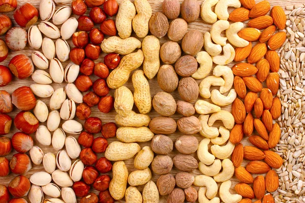Nutmeg, peanuts, hazelnuts and almonds — Stock Photo, Image