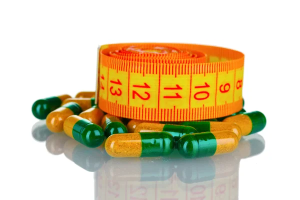 Pilulky na hubnutí a měřicí pásky — Stock fotografie