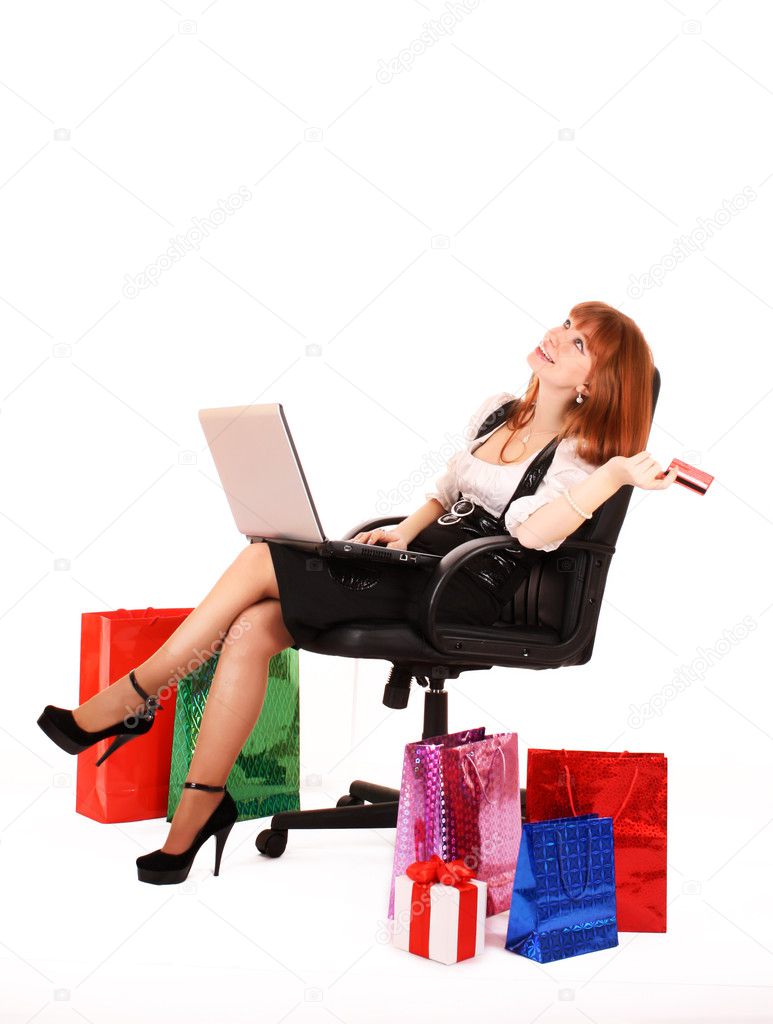 Redhair woman with color shopping bags shopping over internet