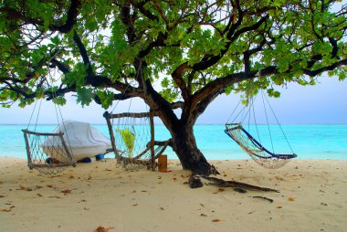 Two hammocks and sea clipart