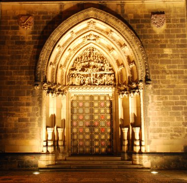 Portal of a czech cathedral in the night clipart