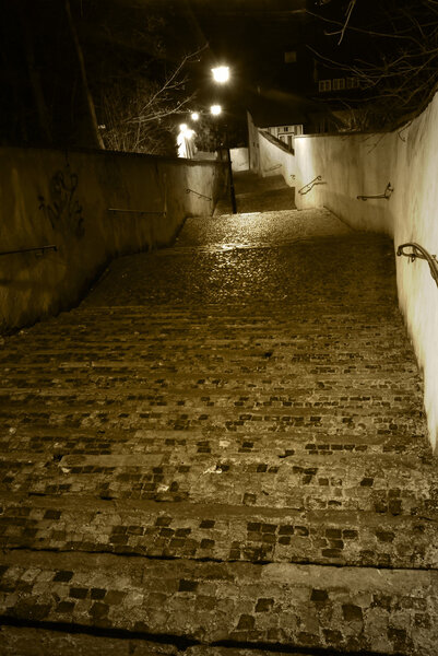 Old castle stairs from Prague castle to Little Quarter in sepia