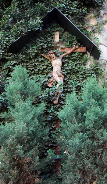 Крест на стене с листьями — стоковое фото